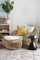 Scott Yetman Outdoor Indoor seating area featuring wicker chairs and a footstool upholstered in Algonquin Performance Print in Limone, a subtly printed dotty stripe design, creating a calm and relaxing space. Photography by Drew Hadley.